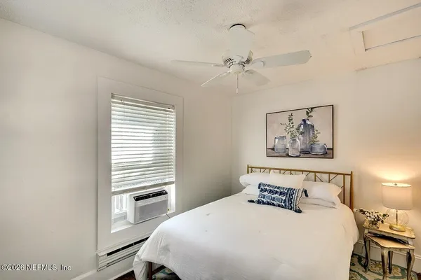 a bedroom with a bed and a window