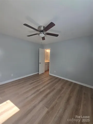 a view of a big room with wooden floor and a ceiling fan
