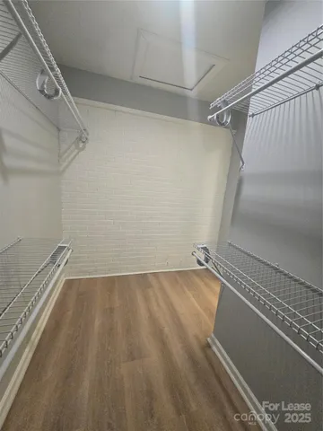 a view of a room with wooden floor