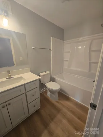 a kitchen with a sink a window a refrigerator and stainless steel appliances