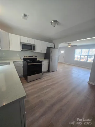 a kitchen with stainless steel appliances and wooden cabinets
