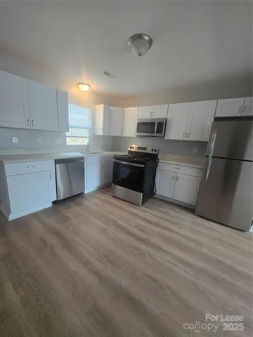 a kitchen with stainless steel appliances a refrigerator sink and stove