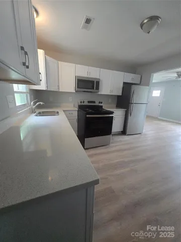 a large kitchen with stainless steel appliances