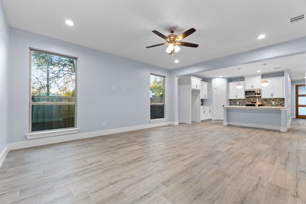 520 East 5th Street Bonham, TX 75418 - Photo 13 of 16 a view of an empty room with a window and wooden floor