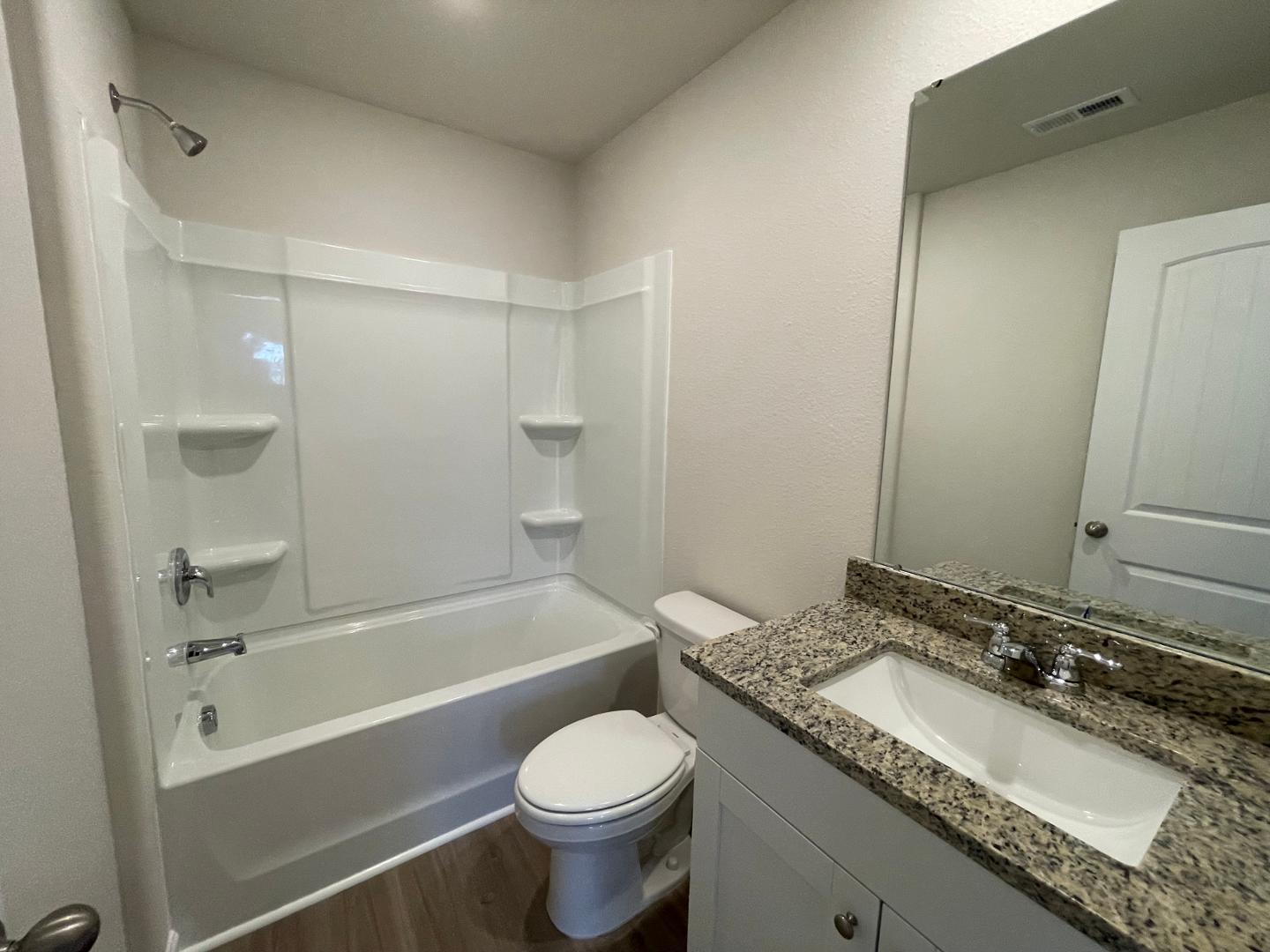 111 Hybrid Street Oxford, NC 27565 - Photo 17 of 25 a bathroom with a granite countertop sink toilet and shower