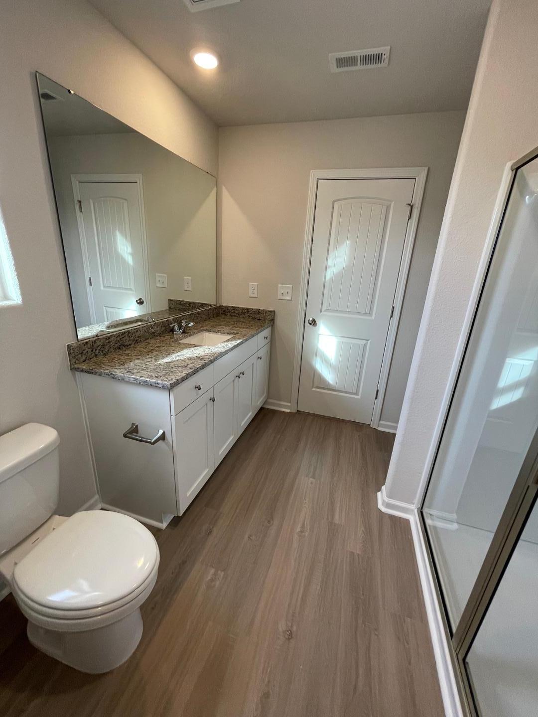 111 Hybrid Street Oxford, NC 27565 - Photo 21 of 25 a bathroom with a granite countertop toilet sink and mirror