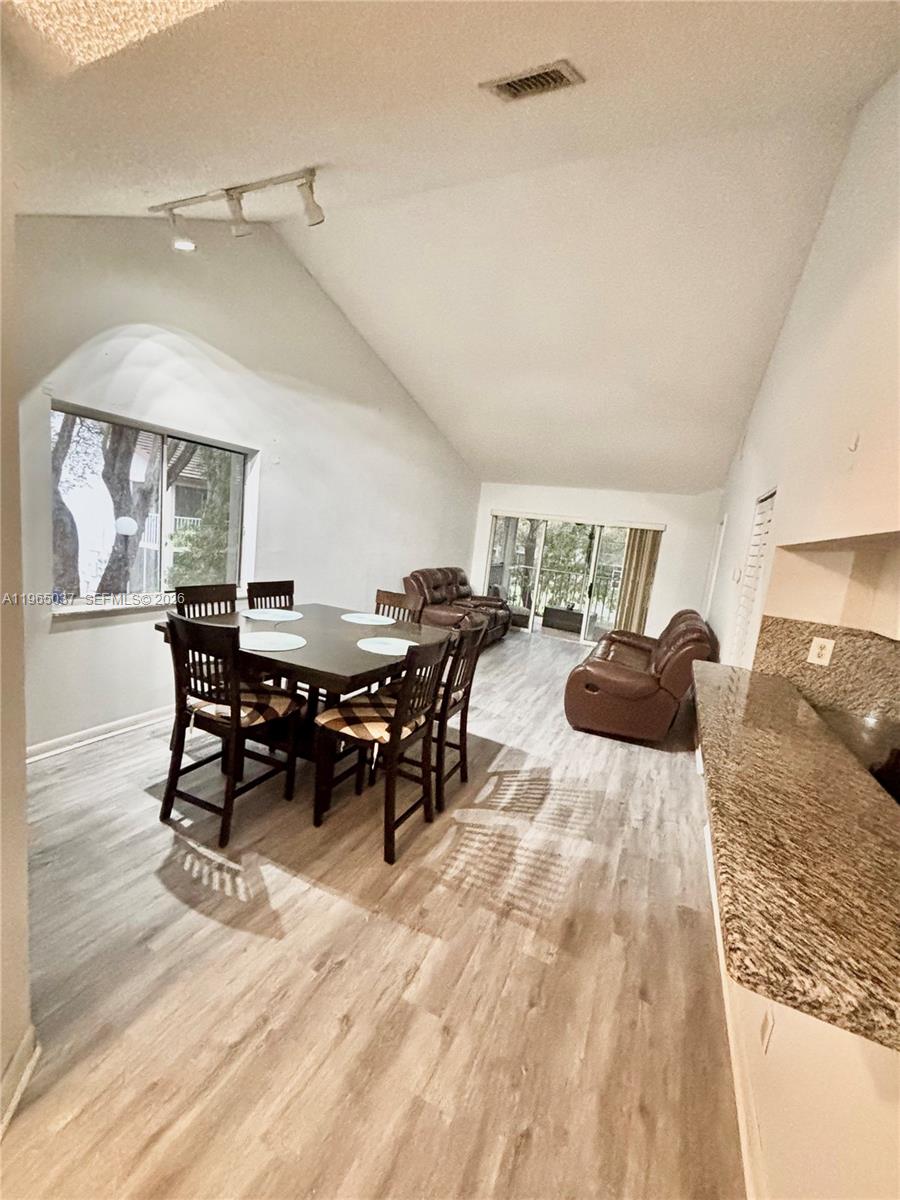 9081 Southwest 138th Place, Unit 9081 Miami, FL 33186 - Photo 1 of 20 a living room with furniture a rug and chairs