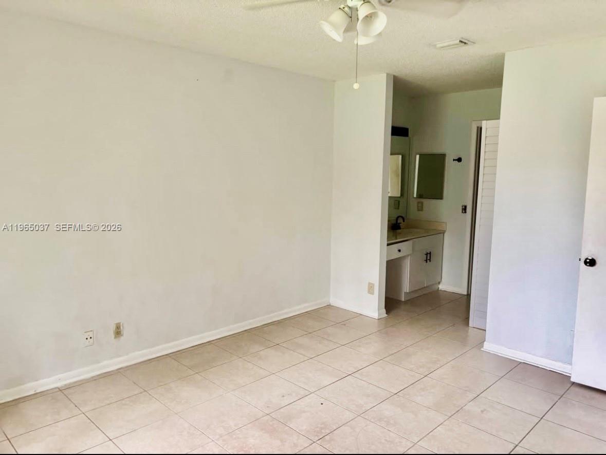 9081 Southwest 138th Place, Unit 9081 Miami, FL 33186 - Photo 11 of 20 an empty room with a bathroom and a sink