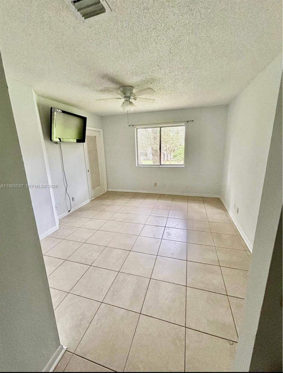 9081 Southwest 138th Place, Unit 9081 Miami, FL 33186 - Photo 12 of 20 a view of a hallway to a room