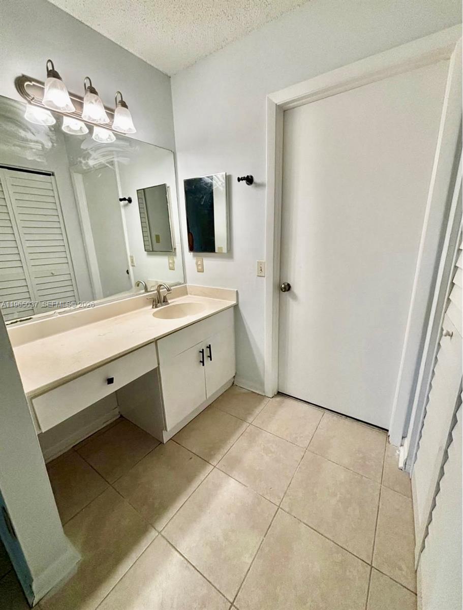 9081 Southwest 138th Place, Unit 9081 Miami, FL 33186 - Photo 14 of 20 a bathroom with a double vanity sink mirror and