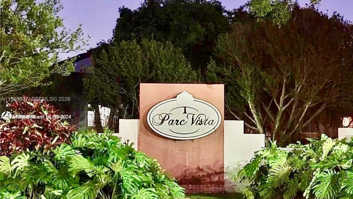 9081 Southwest 138th Place, Unit 9081 Miami, FL 33186 - Photo 17 of 20 a sign that is sitting in front of flowers
