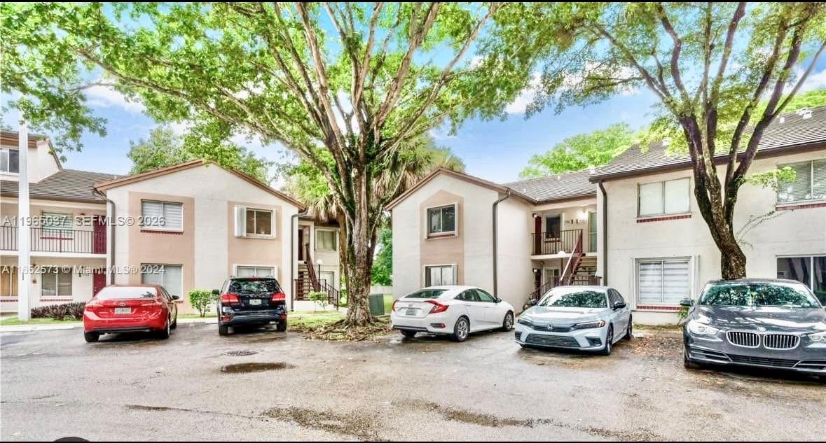 9081 Southwest 138th Place, Unit 9081 Miami, FL 33186 - Photo 19 of 20 a car parked in front of a white house