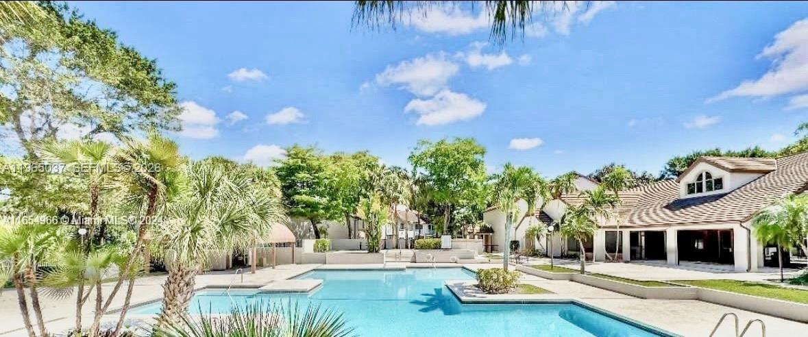9081 Southwest 138th Place, Unit 9081 Miami, FL 33186 - Photo 20 of 20 a view of a swimming pool with a patio