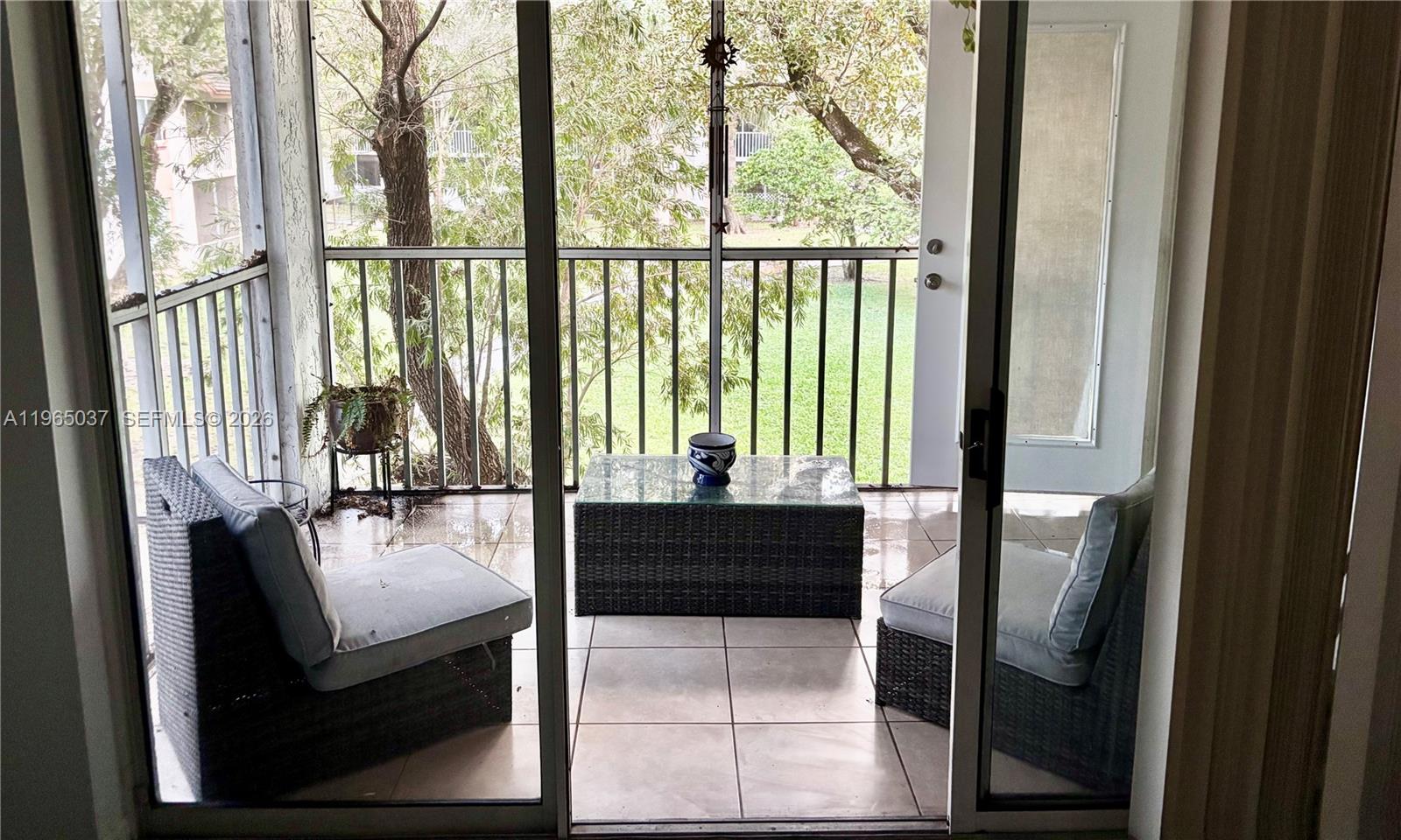 9081 Southwest 138th Place, Unit 9081 Miami, FL 33186 - Photo 5 of 20 view of living room with furniture and floor to ceiling window