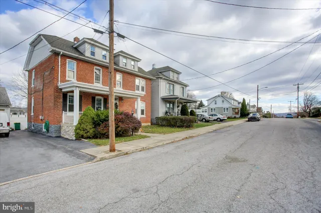 a view of a city street with tall buildings