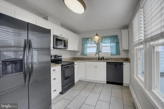a kitchen with a refrigerator and a sink