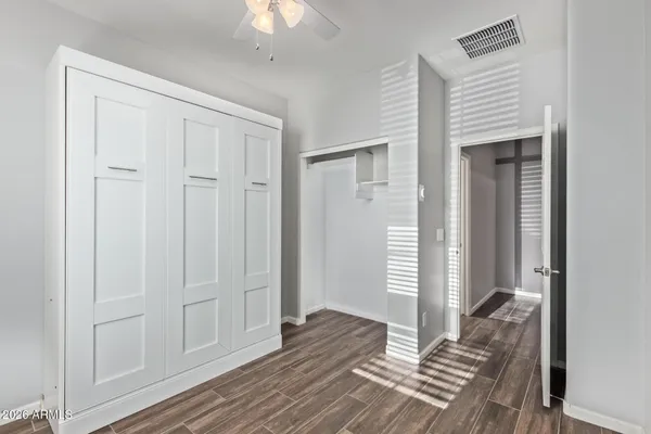 a bathroom with a granite countertop toilet sink and mirror