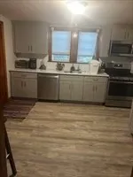 a kitchen with stainless steel appliances granite countertop a sink stove and cabinets