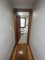 36 St Marks Road, Unit 2 Boston, MA 02124 - Photo 11 of 14 a view of a hallway with wooden floor and a bathroom
