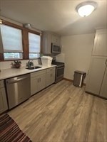 36 St Marks Road, Unit 2 Boston, MA 02124 - Photo 4 of 14 a large kitchen with a sink and cabinets