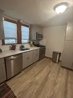 a kitchen with sink cabinets and window