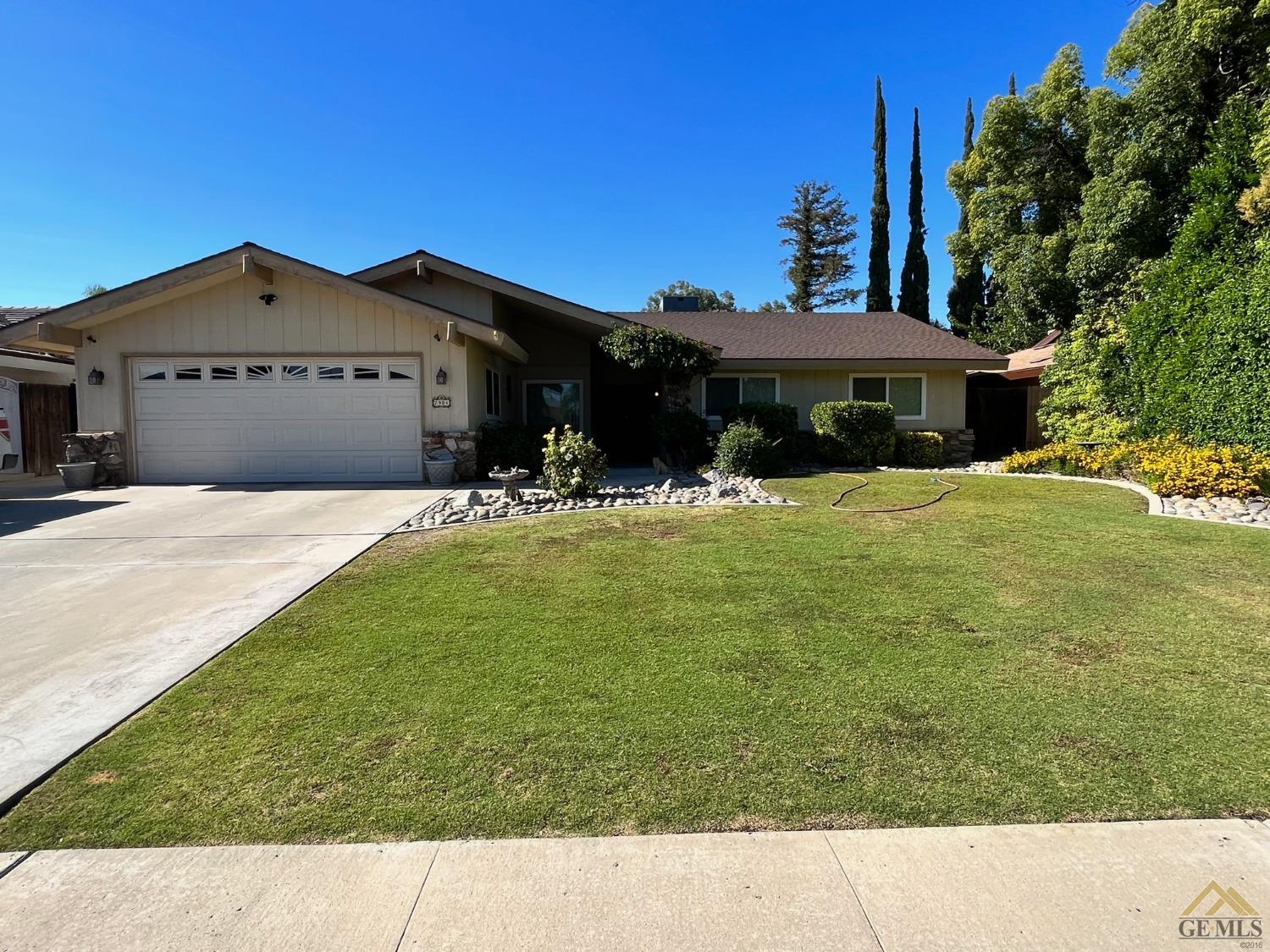 a view of house with yard and outdoor