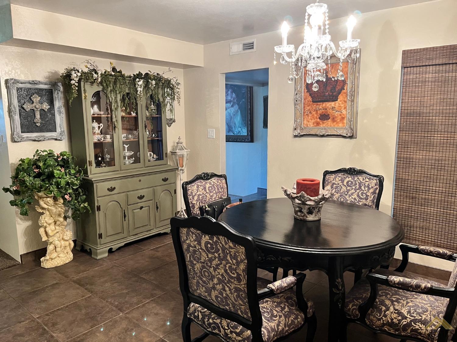 Undisclosed Address Bakersfield, CA 93309 - Photo 11 of 28 a dining room with furniture and chandelier