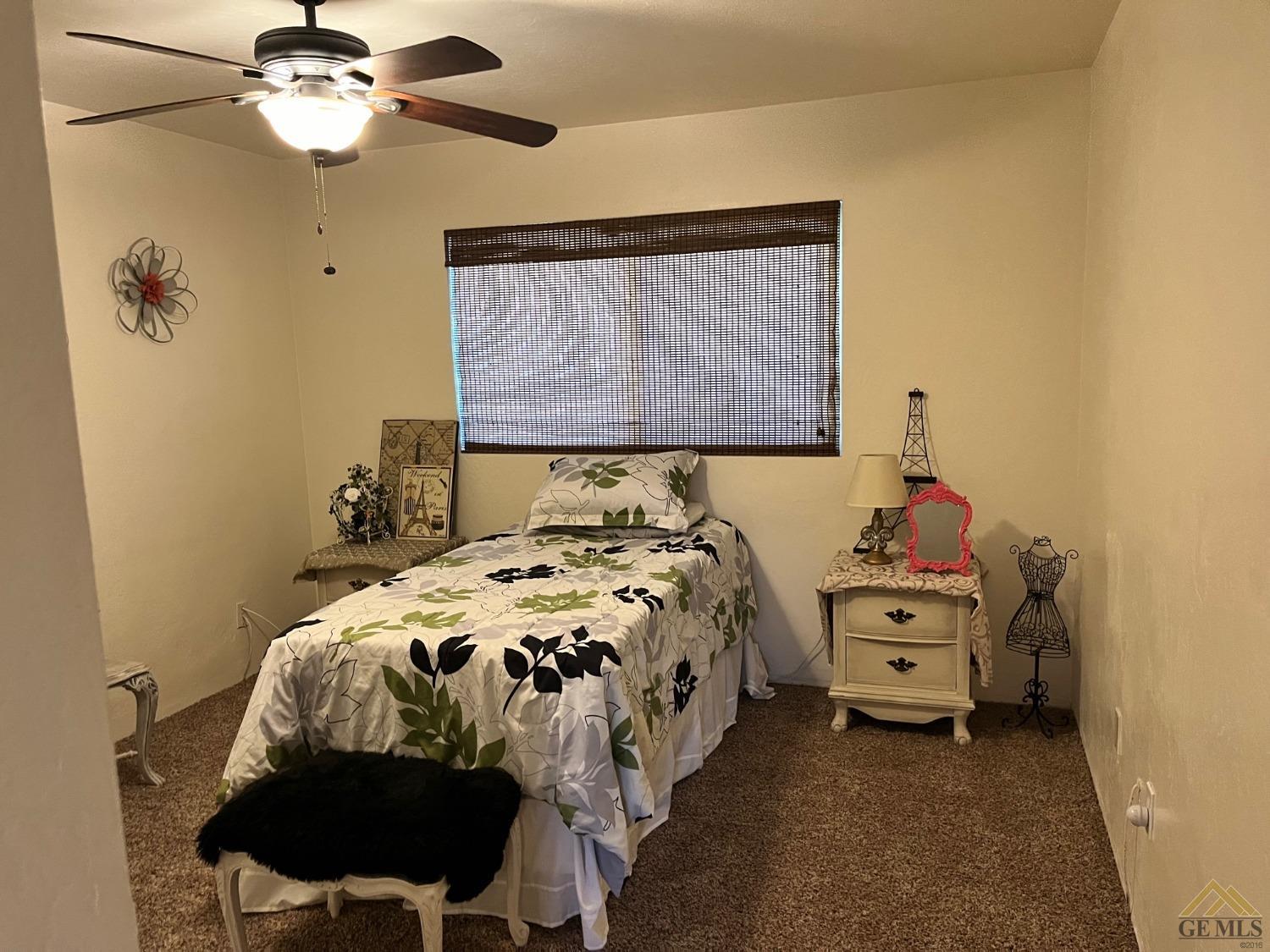 Undisclosed Address Bakersfield, CA 93309 - Photo 17 of 28 a bedroom with a bed and a chandelier