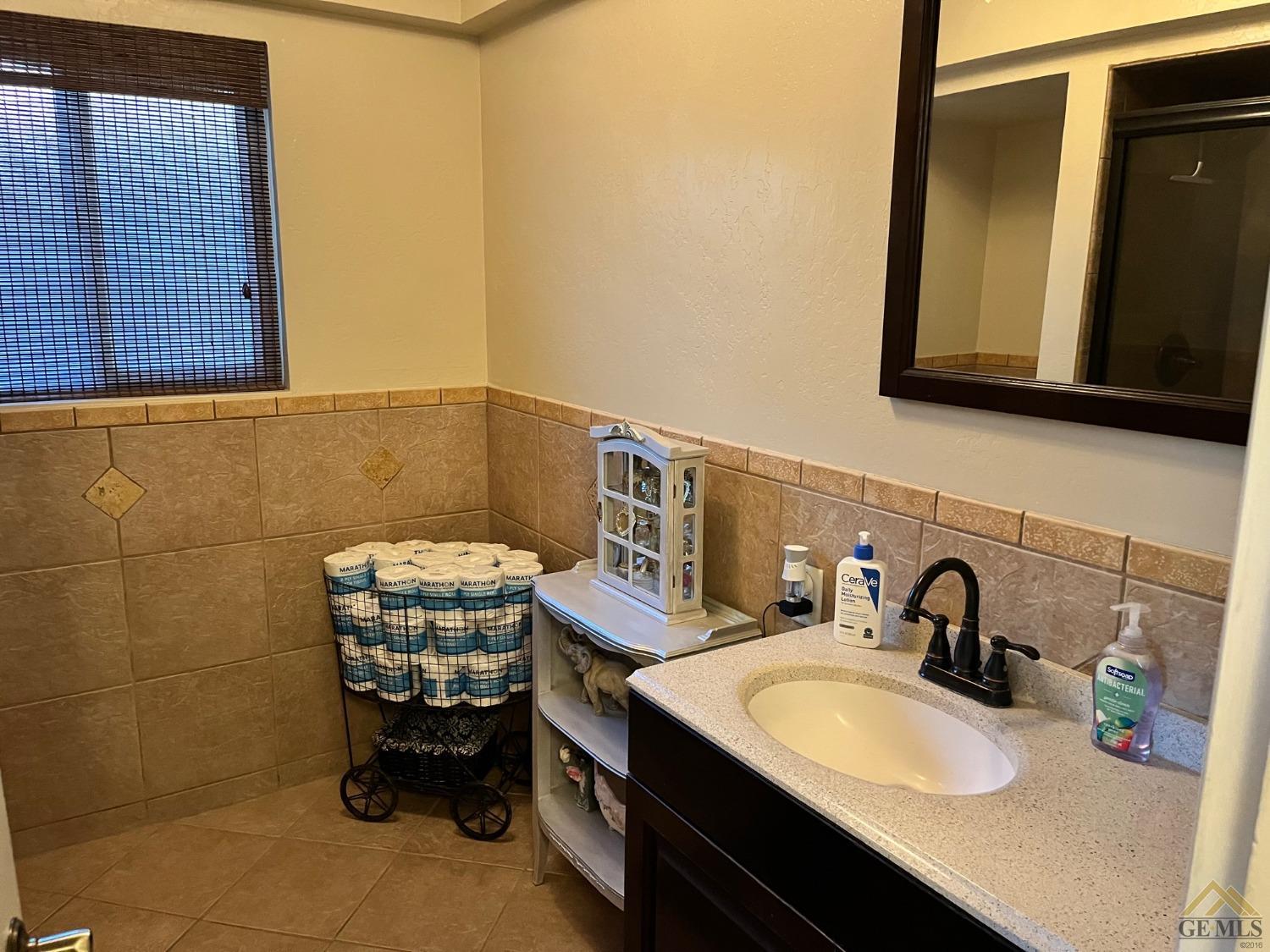 Undisclosed Address Bakersfield, CA 93309 - Photo 19 of 28 a bathroom with a sink and a mirror