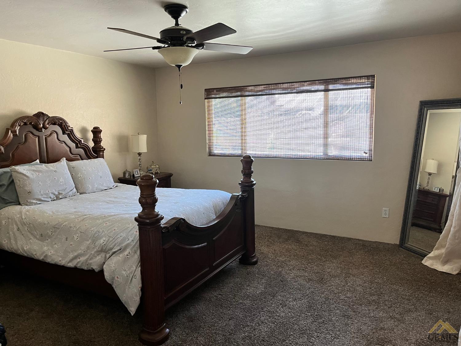 Undisclosed Address Bakersfield, CA 93309 - Photo 21 of 28 a bed sitting in a bedroom next to a window
