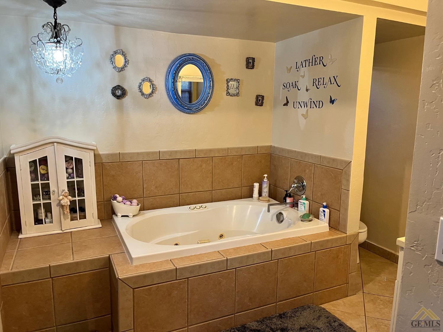 Undisclosed Address Bakersfield, CA 93309 - Photo 22 of 28 a bathroom with a bathtub and a shower