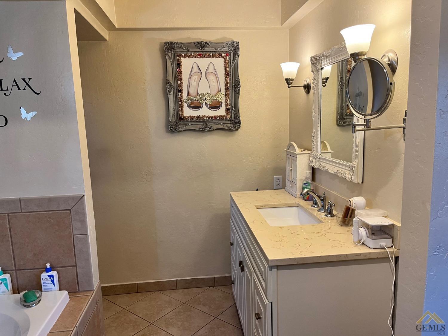 Undisclosed Address Bakersfield, CA 93309 - Photo 23 of 28 a bathroom with a sink and a mirror