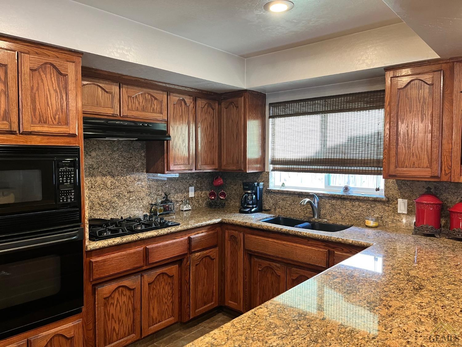 Undisclosed Address Bakersfield, CA 93309 - Photo 7 of 28 a kitchen with stainless steel appliances granite countertop a sink stove and cabinets