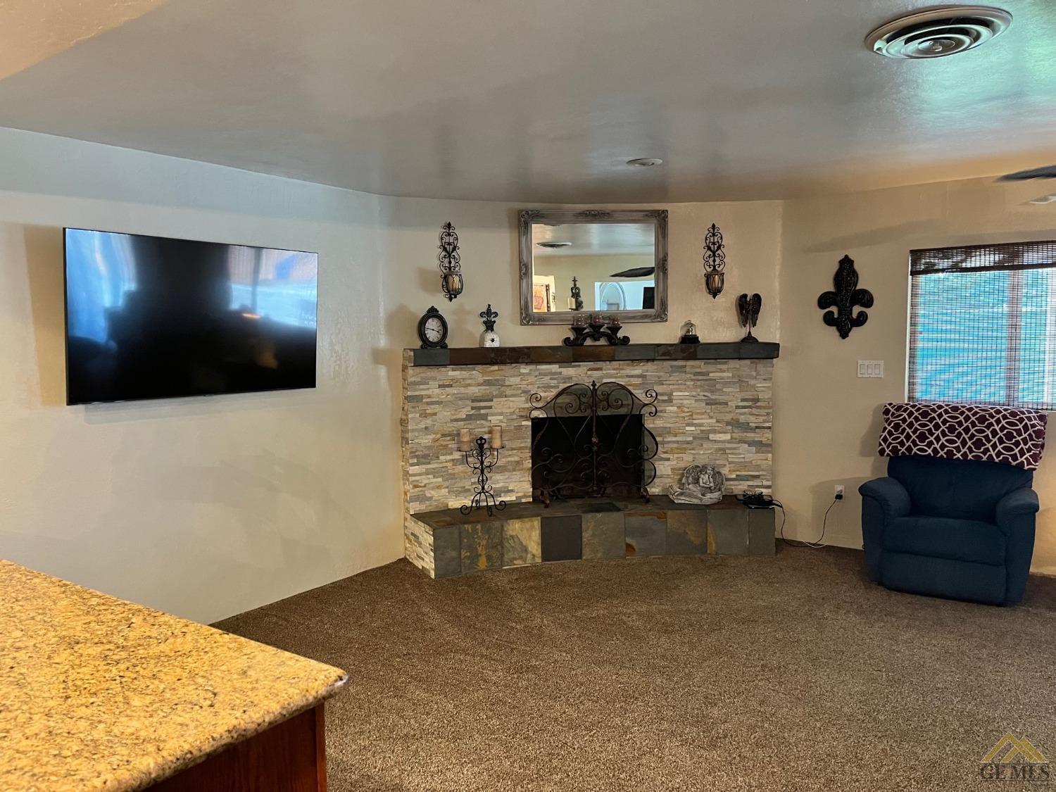 Undisclosed Address Bakersfield, CA 93309 - Photo 8 of 28 a living room with furniture and a flat screen tv