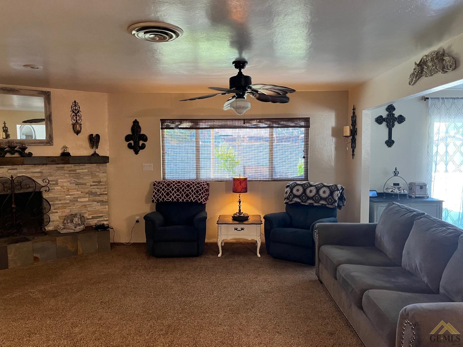 Undisclosed Address Bakersfield, CA 93309 - Photo 9 of 28 a living room with furniture ceiling fan and a window