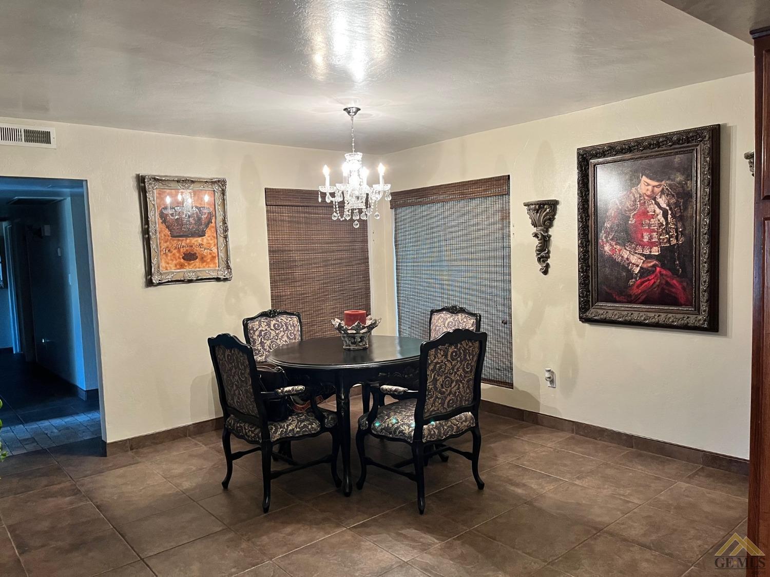 Undisclosed Address Bakersfield, CA 93309 - Photo 10 of 28 a view of a dining room with furniture and chandelier
