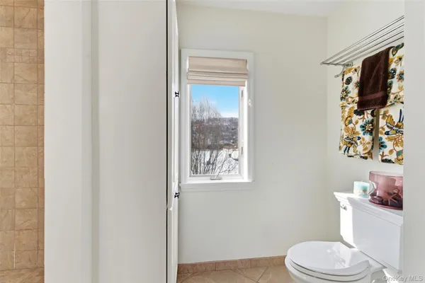 a white toilet sitting next to a bathroom sink