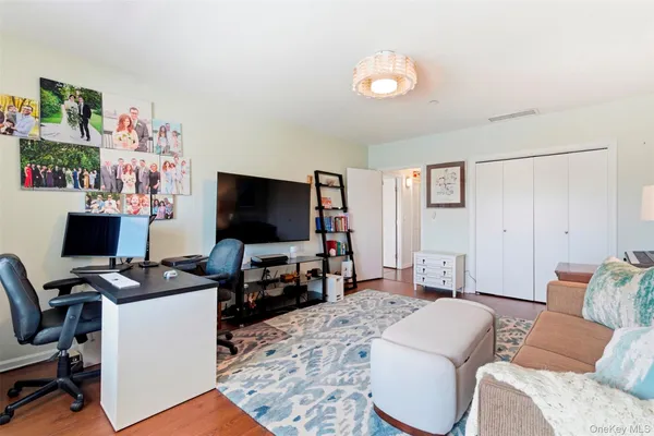 a bedroom with furniture and a flat screen tv