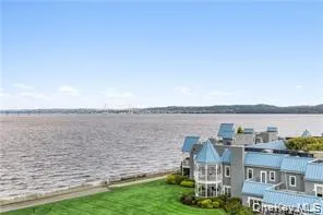 a view of a patio with lawn chairs next to a yard