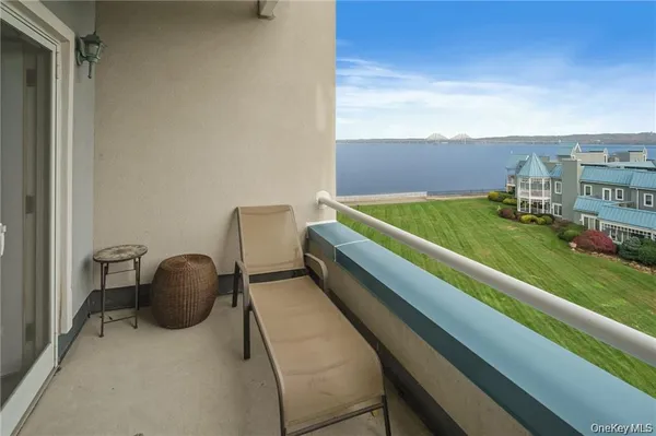 a balcony with table and chairs