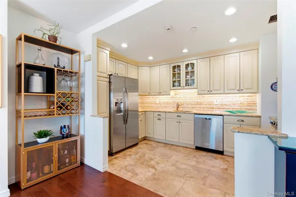 a kitchen with granite countertop stainless steel appliances and wooden cabinets