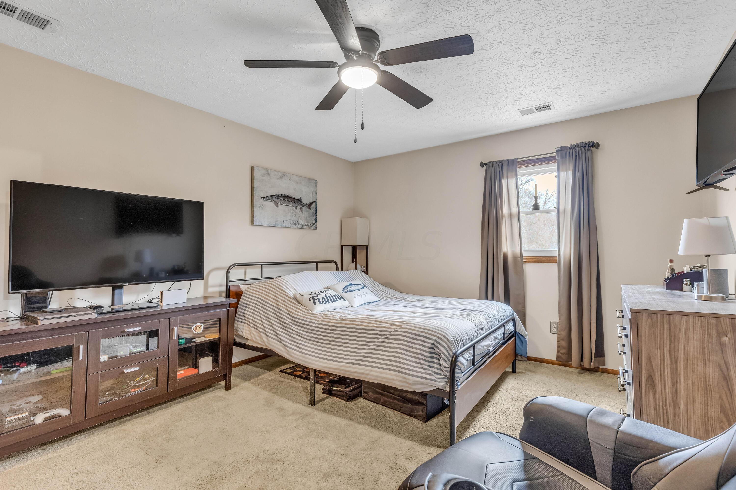 435 Emory Street Gahanna, OH 43230 - Photo 35 of 54 • Light sand carpet
• Tan painted walls
• Lighted ceiling fan
• Drapes remain