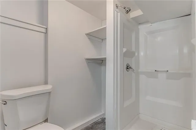 a bathroom with a sink toilet and mirror