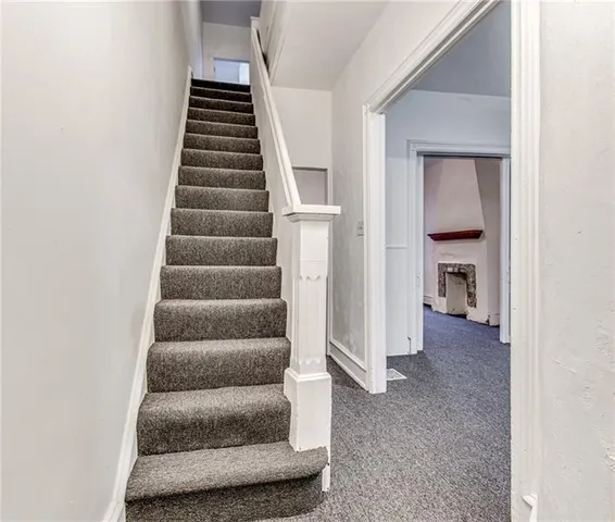a view of entryway and hall with wooden floor