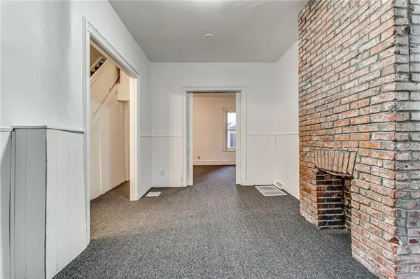 a view of empty room with closet and windows