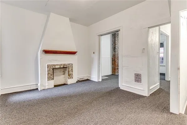 a view of an empty room with a fireplace