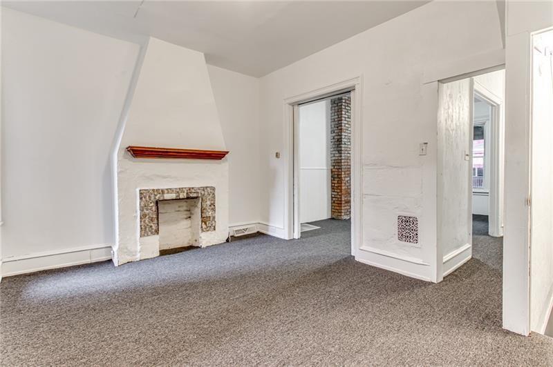 354 Ophelia Street Pittsburgh, PA 15213 - Photo 8 of 28 a view of an empty room with a fireplace