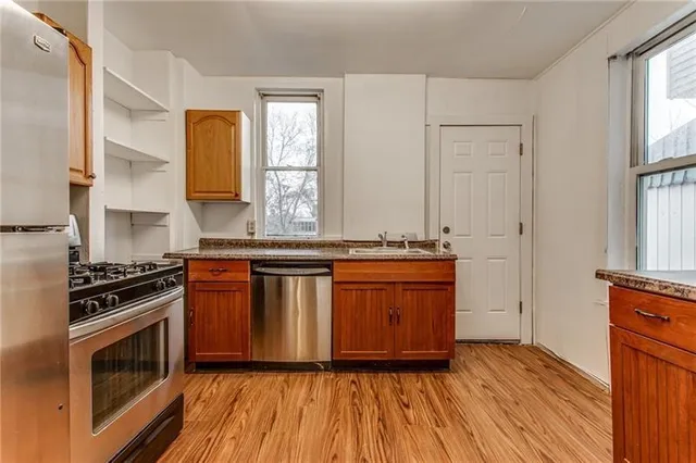a kitchen with granite countertop a stove and a sink