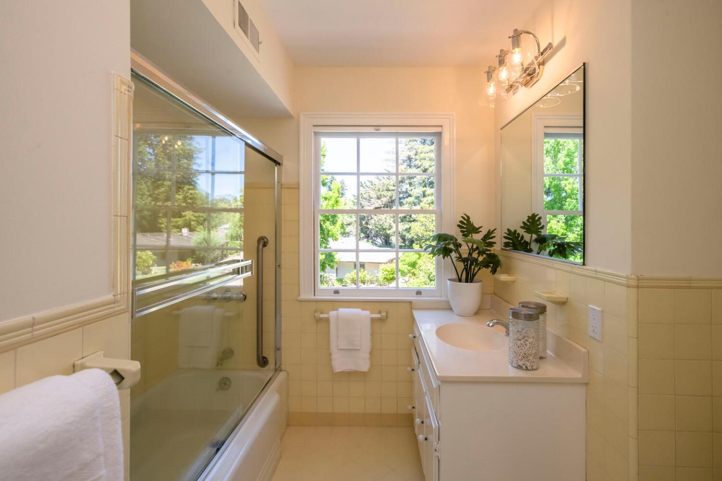 7 Windsor Drive Hillsborough, CA 94010 - Photo 27 of 57 a bathroom with a sink a window and a mirror