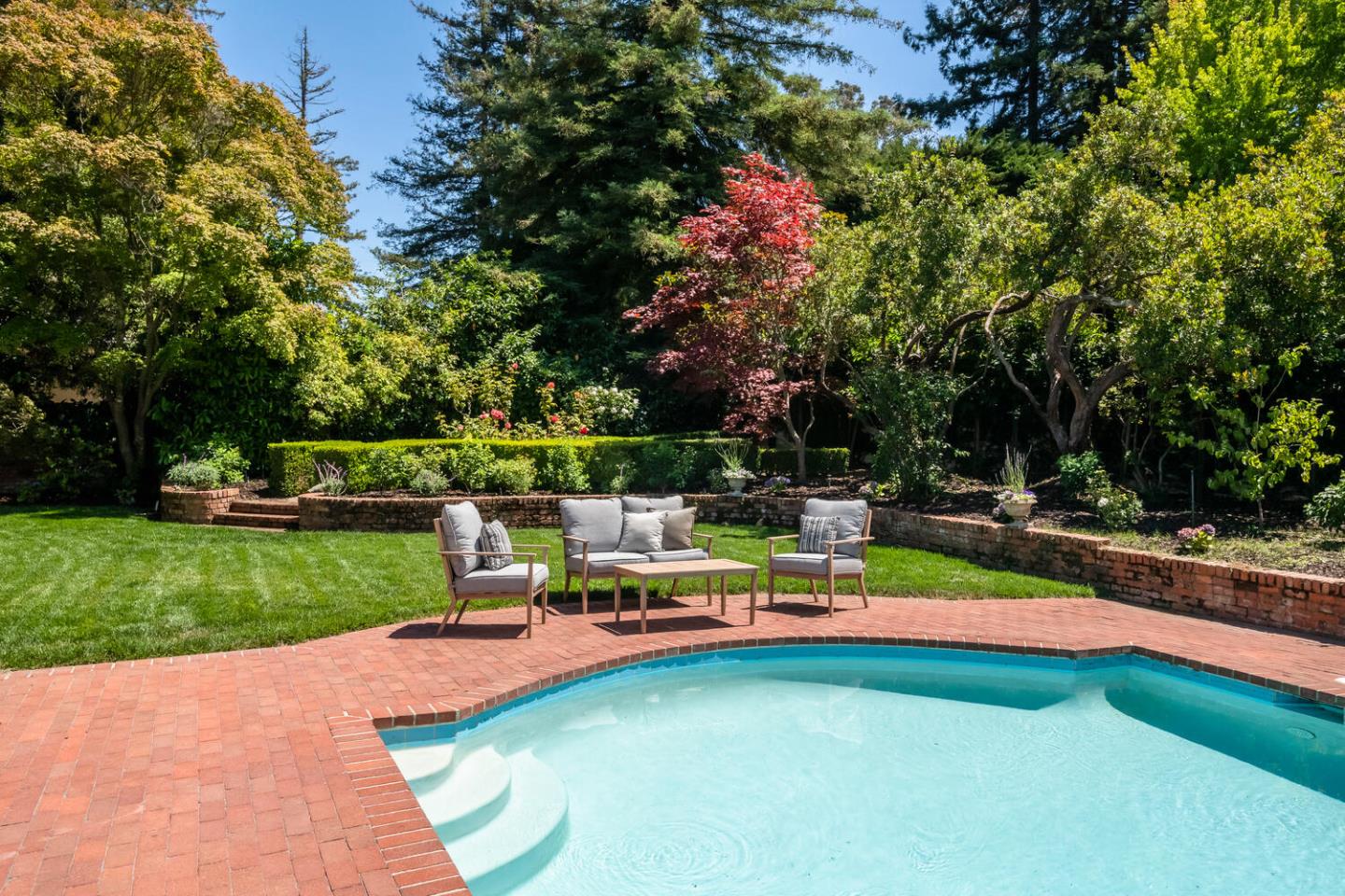 7 Windsor Drive Hillsborough, CA 94010 - Photo 44 of 57 a view of a swimming pool with a garden and sitting area